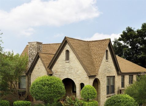 A gorgeous beige brick house with new roofing.