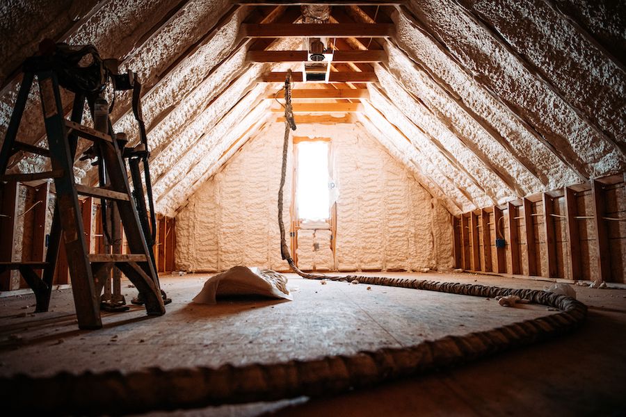 An inside view of an attic covered with spray foam