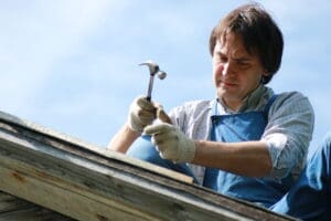 Amish roofing crew installing asphalt shingles on residential home