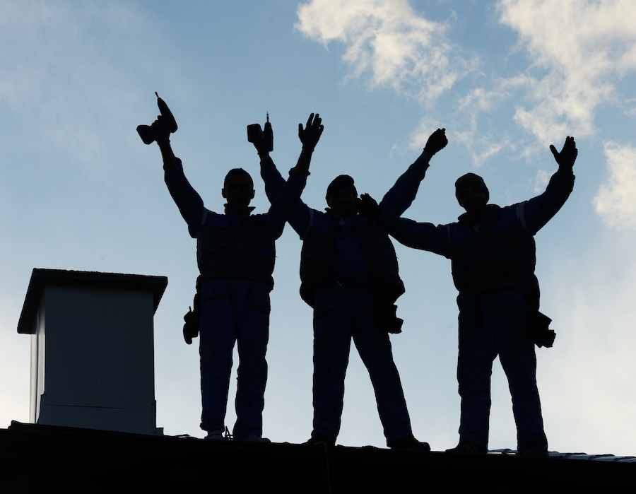 Roofing contractors completing roof replacement in Northeast Ohio neighborhood