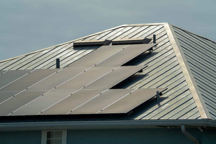 Solar Panels on Metal Roof in Suburban Area
