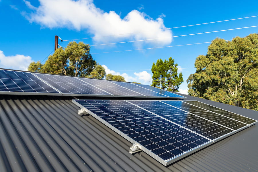 Solar Panels on Roof with Blue Sky Above
