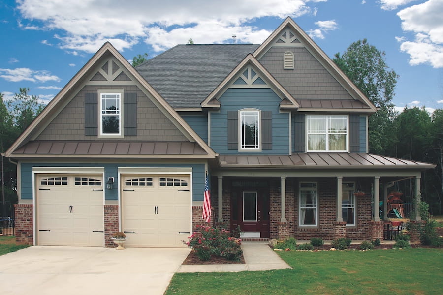 Residential home exterior showcasing James Hardie siding styles with mixed textures and professional installation