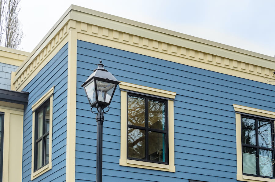 Blue Building with Black Light Post and Windows

